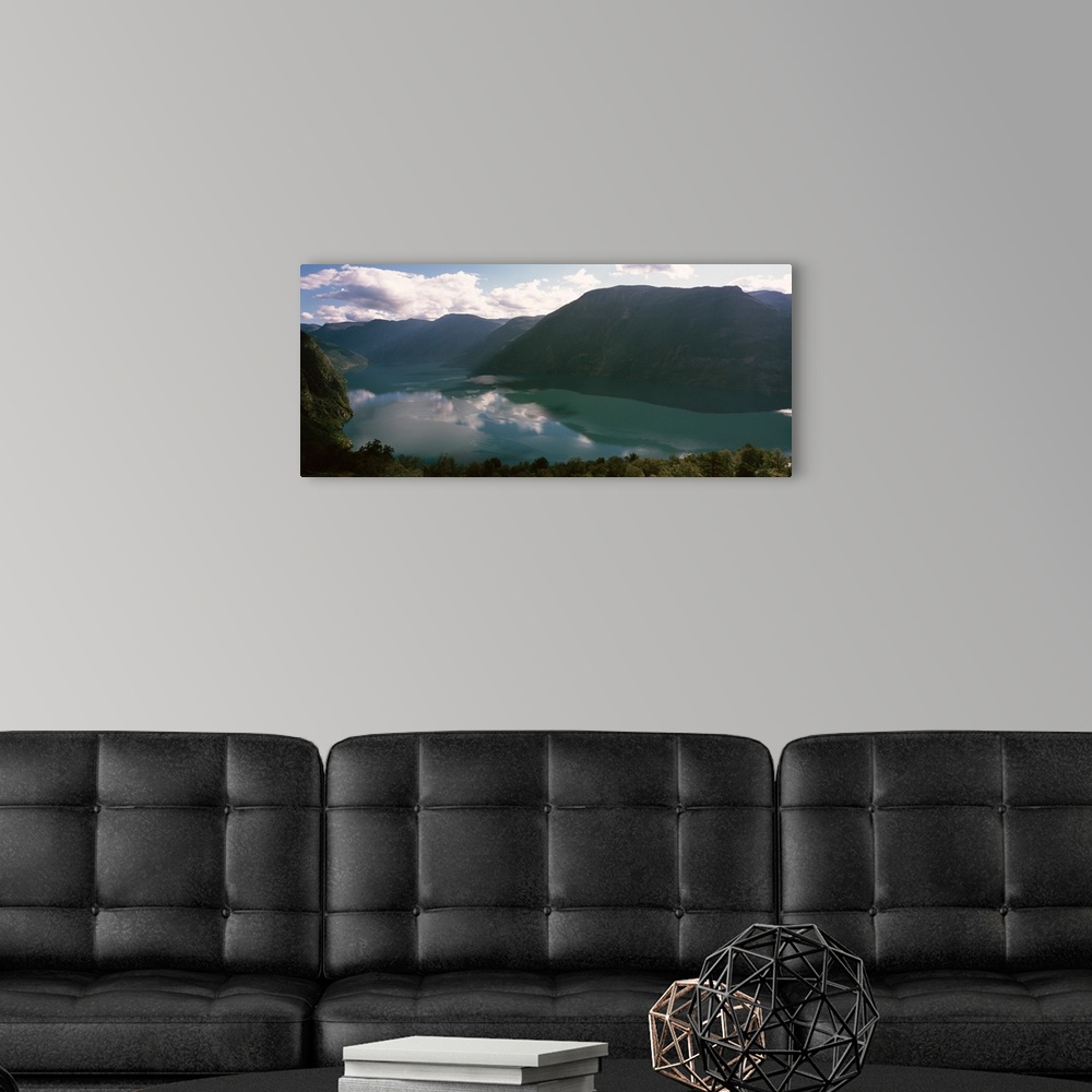 A modern room featuring Reflections of clouds and mountains in a lake, Geirangerfjord, More og Romsdal, Norway