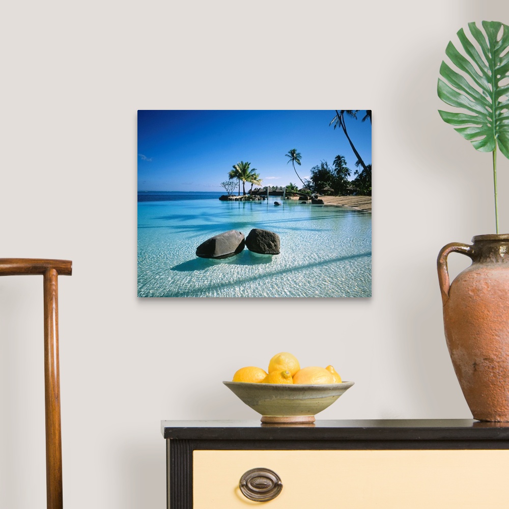 A traditional room featuring Large landscape artwork for a living room or office of clear water ripples around rocks on a trop...