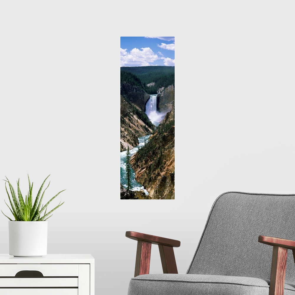 A modern room featuring Vertical panoramic of a large waterfall at Yellowstone National Park in Wyoming.