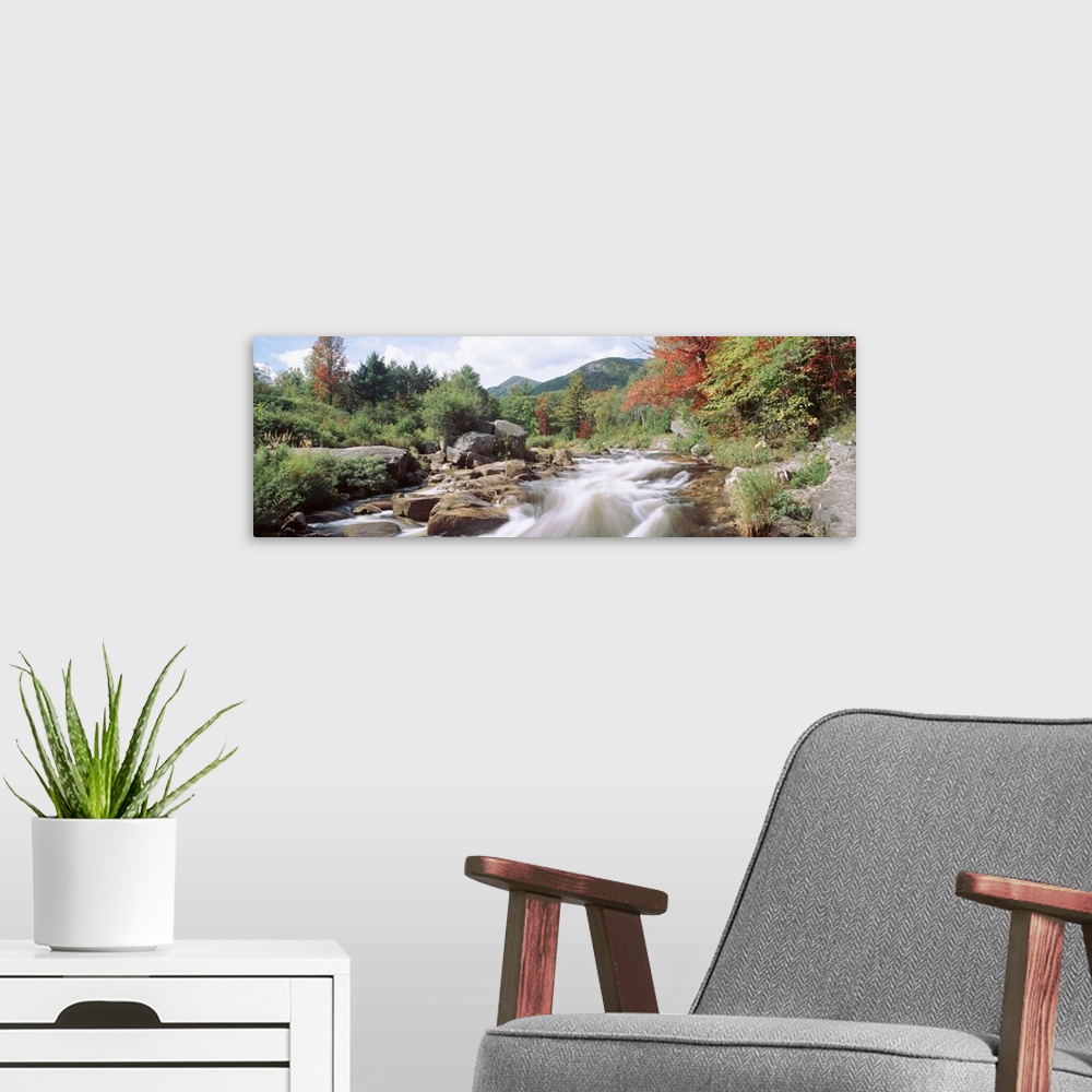 A modern room featuring Flowing rapids on the Ausable River on an early fall day in Wilmington, New York.