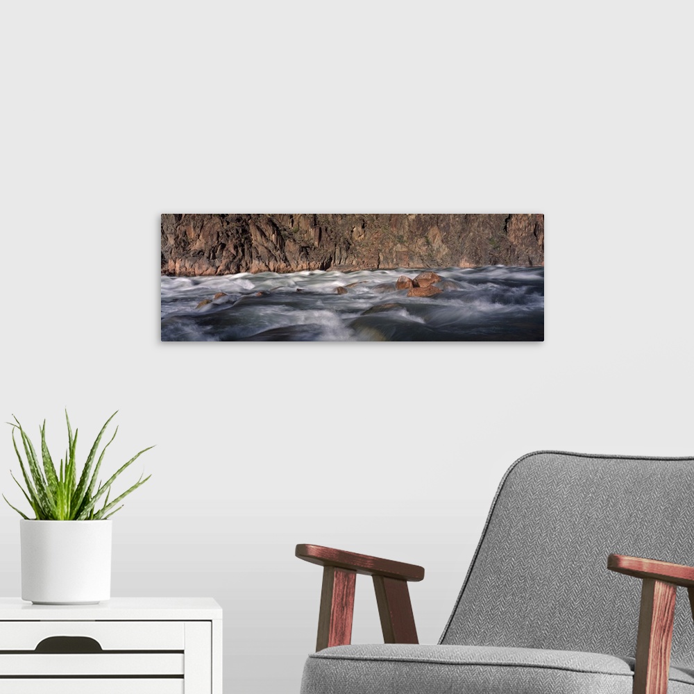 A modern room featuring Panoramic image of the rushing Colorado River rapids at the Grand Canyon in Arizona.