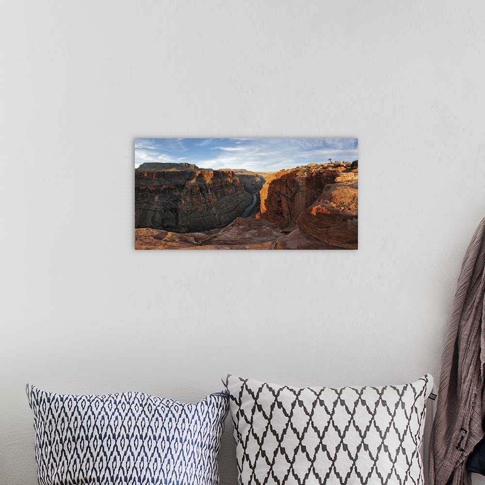 A bohemian room featuring Large canvas photo of Grand Canyon cliffs draped in sunlight and shadows with a river running thr...
