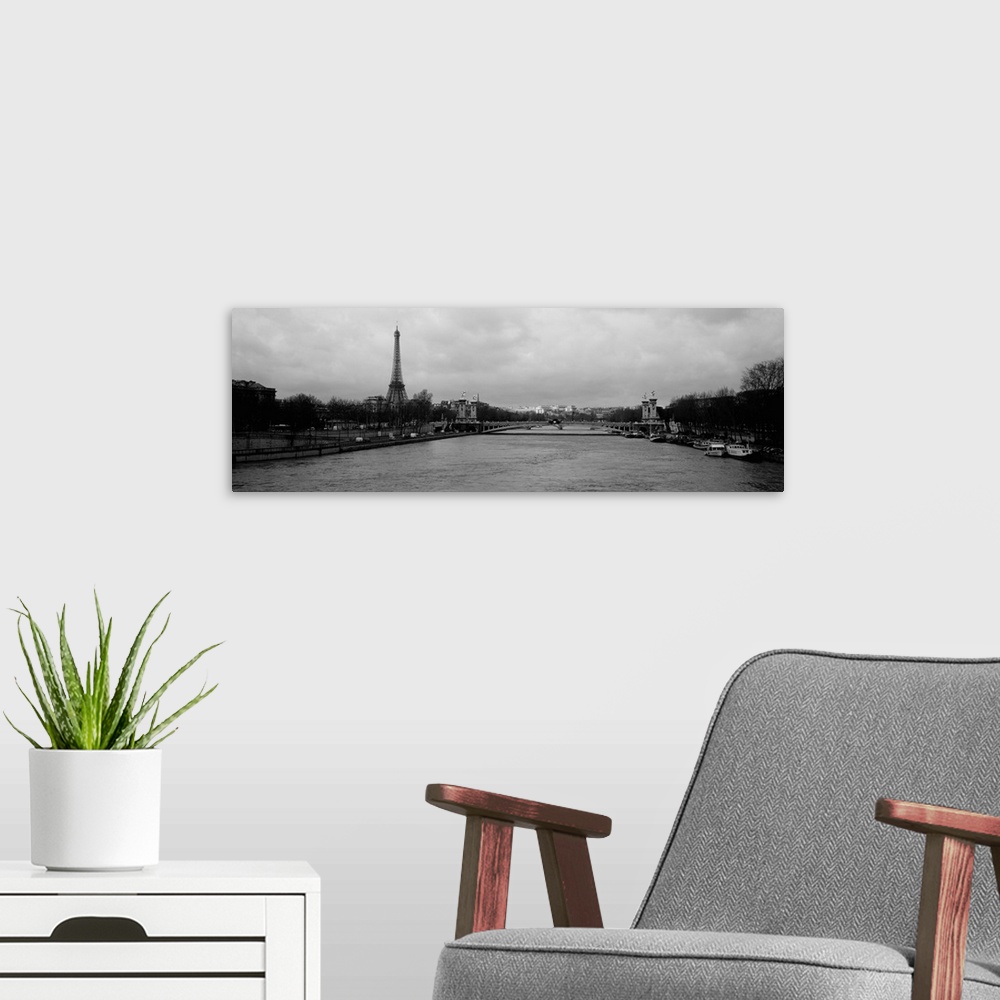 A modern room featuring Panoramic photograph taken over the Seine river with the Eiffel tower in the distance and skewed ...