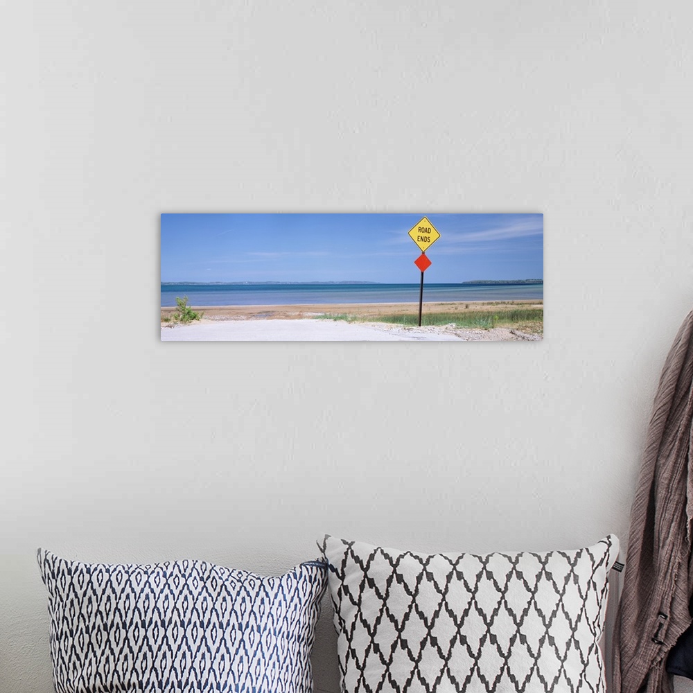 A bohemian room featuring Photograph taken at the end of a road which looks out onto a beach and the ocean.