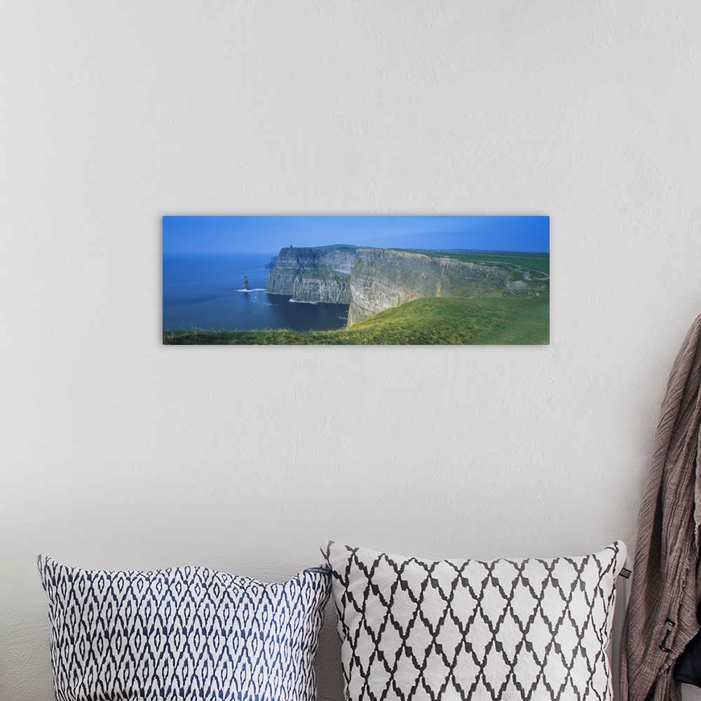 A bohemian room featuring Wide angle photograph of curving, large rock formations of the Cliffs of Moher, leading into the ...