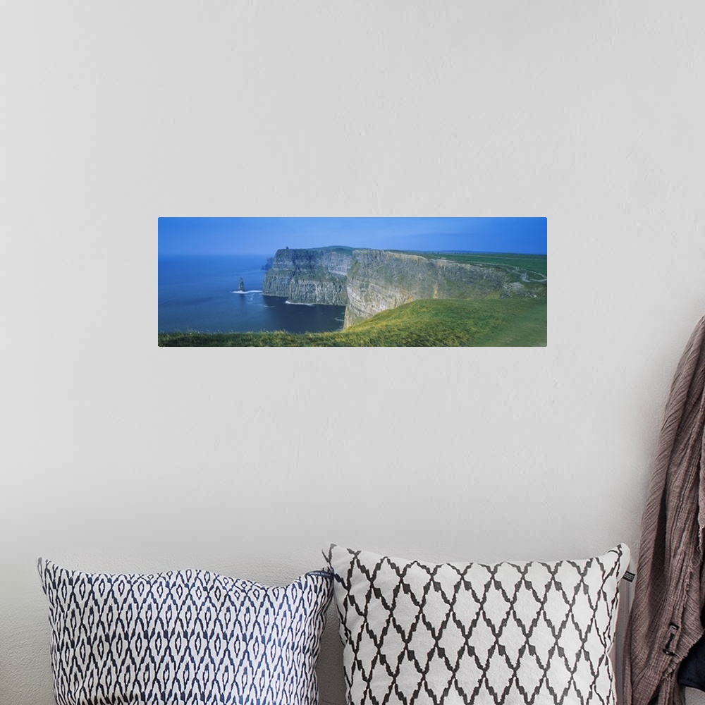 A bohemian room featuring Wide angle photograph of curving, large rock formations of the Cliffs of Moher, leading into the ...