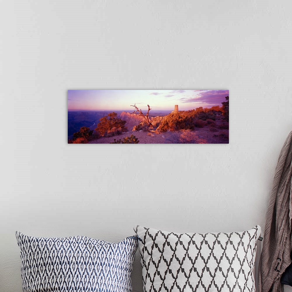 A bohemian room featuring This wall art is a panoramic of a desert landscape taken from the top of a canyon wall.