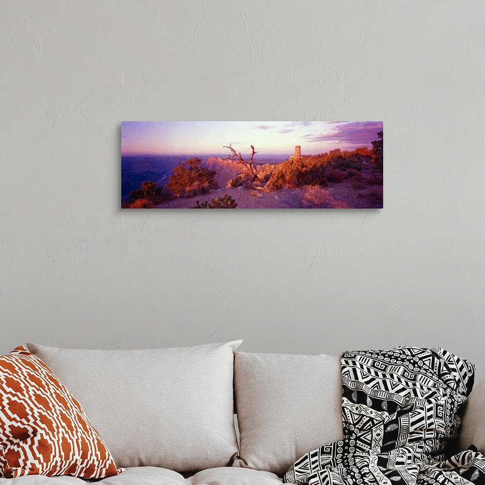 A bohemian room featuring This wall art is a panoramic of a desert landscape taken from the top of a canyon wall.
