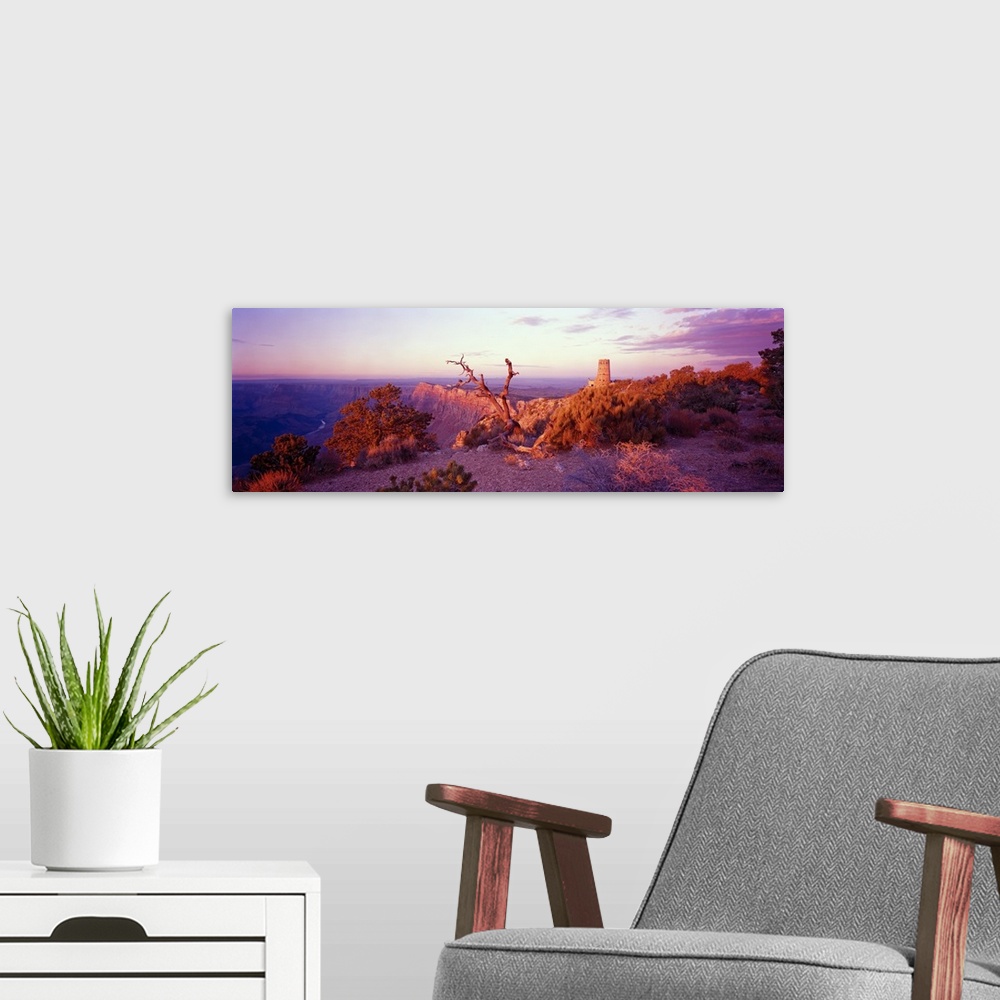 A modern room featuring This wall art is a panoramic of a desert landscape taken from the top of a canyon wall.