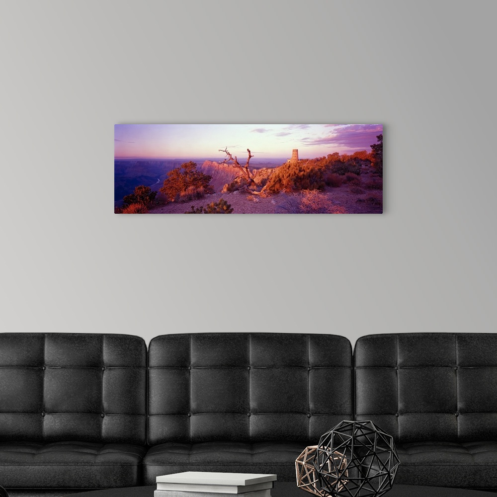 A modern room featuring This wall art is a panoramic of a desert landscape taken from the top of a canyon wall.