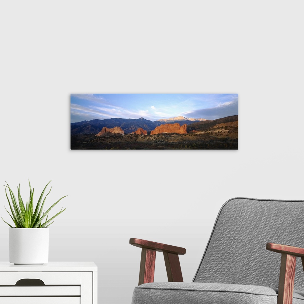 A modern room featuring Panoramic photograph displays a stretch of open terrain in the Western United States.  In the mid...