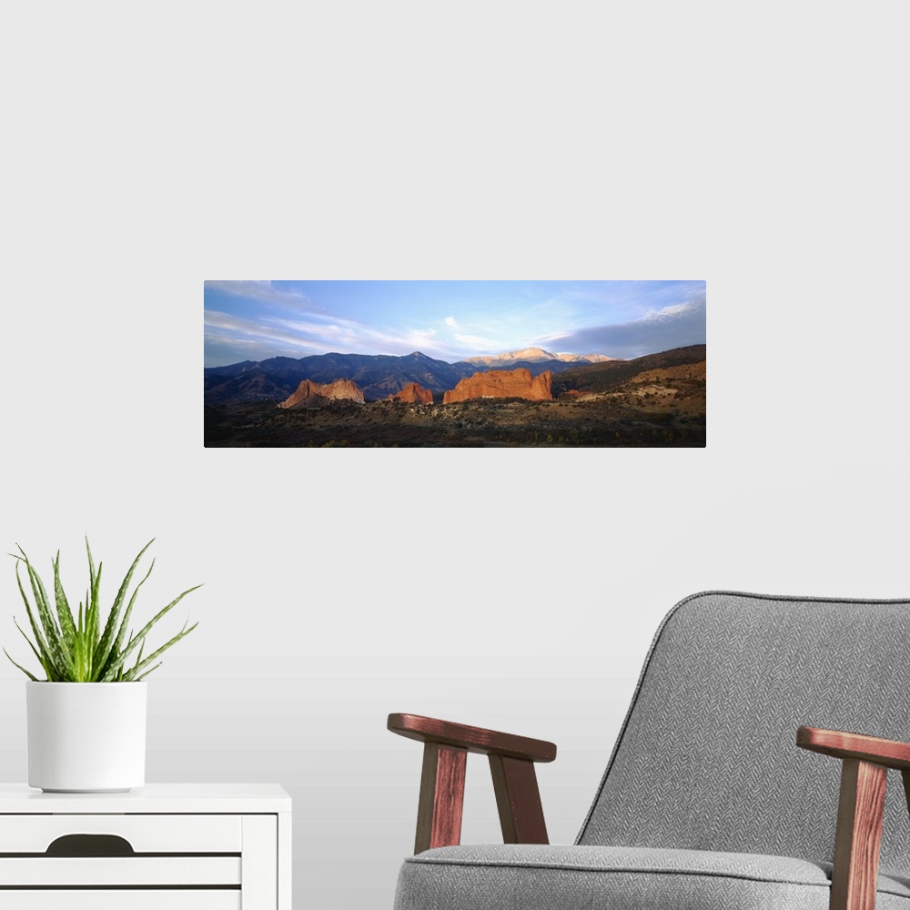 A modern room featuring Panoramic photograph displays a stretch of open terrain in the Western United States.  In the mid...