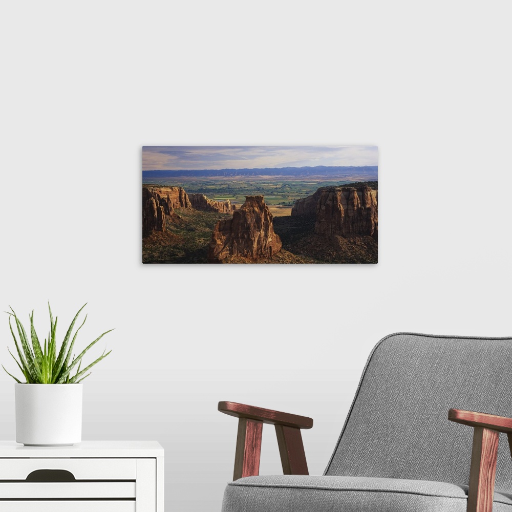 A modern room featuring Big, landscape photograph of large rocks of the Colorado National Monument in Grand Junction, Col...
