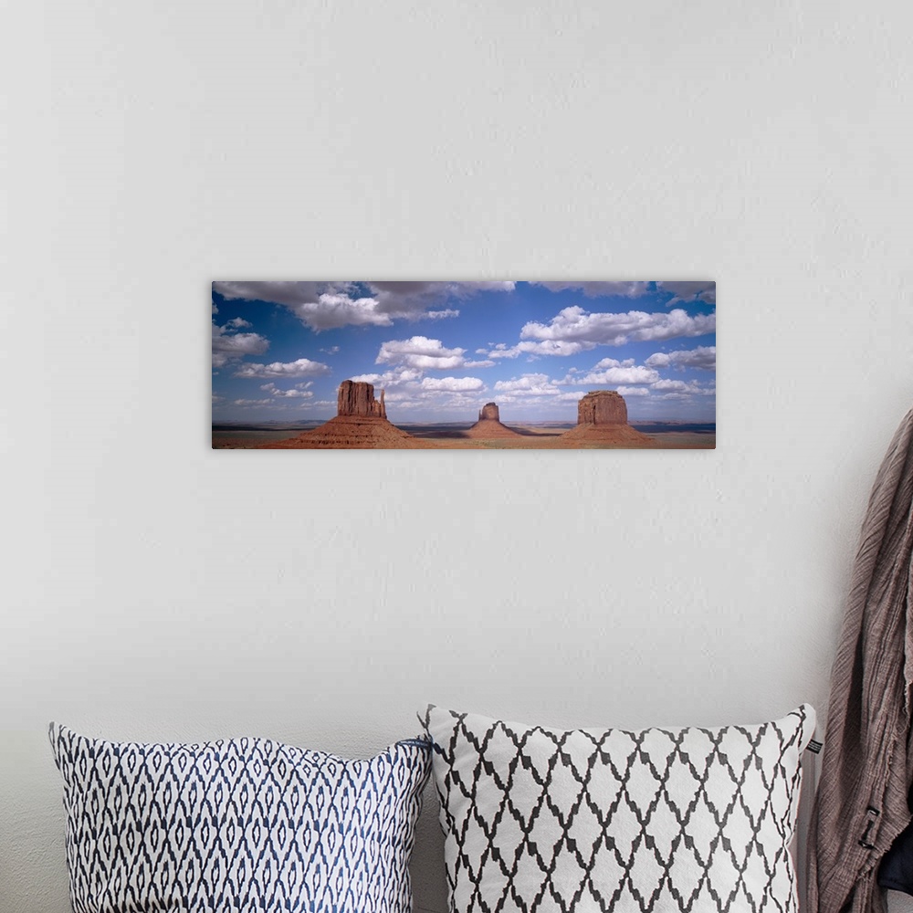 A bohemian room featuring Rock formations on a landscape, The Mittens, Monument Valley, Arizona