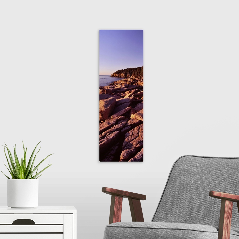 A modern room featuring Rock formations on the coast at sunset