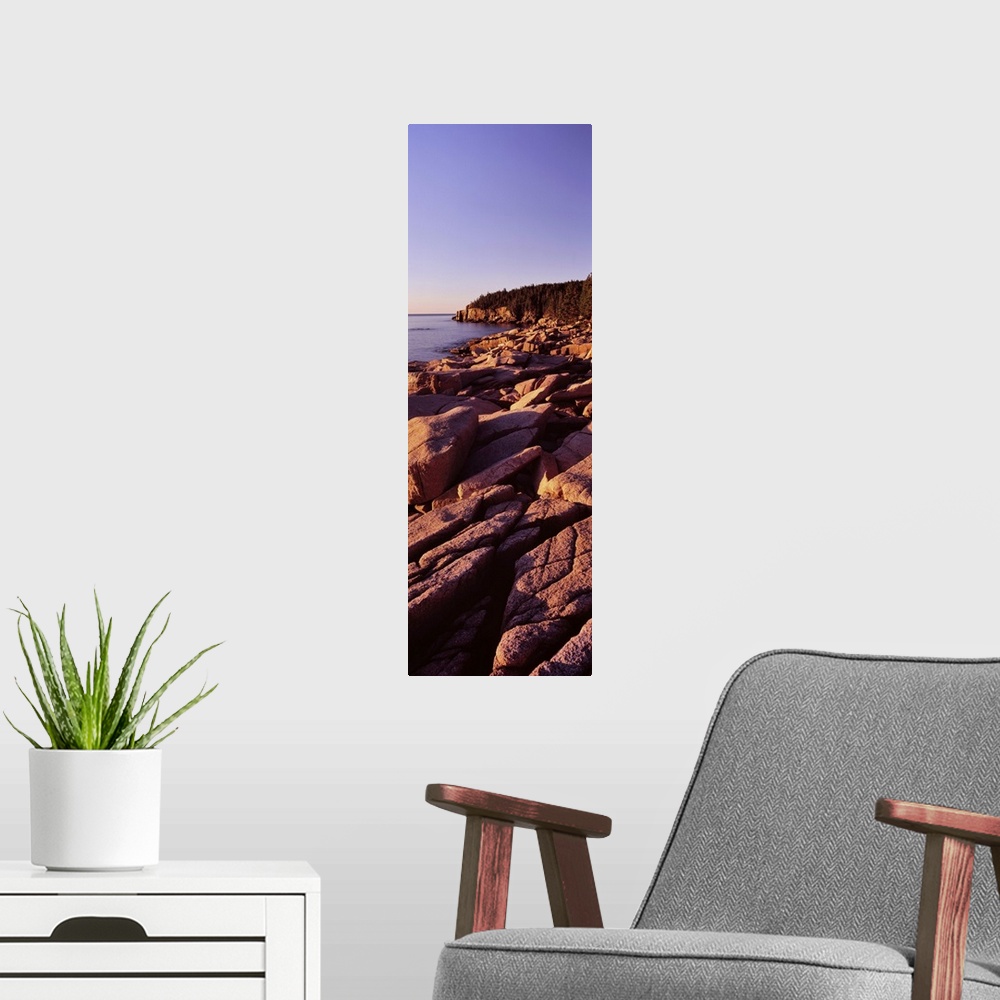 A modern room featuring Rock formations on the coast at sunset