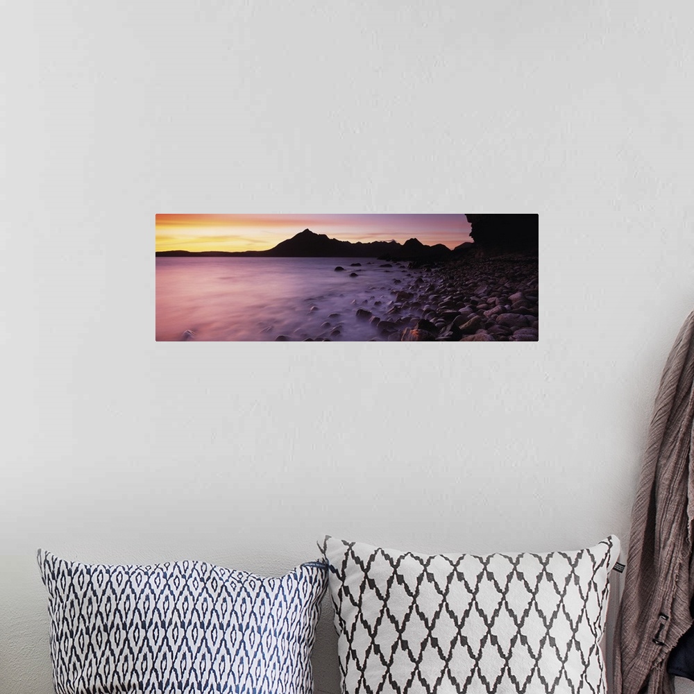 A bohemian room featuring Panoramic photograph of pebble covered shoreline rising from mist with mountain silhouette in the...