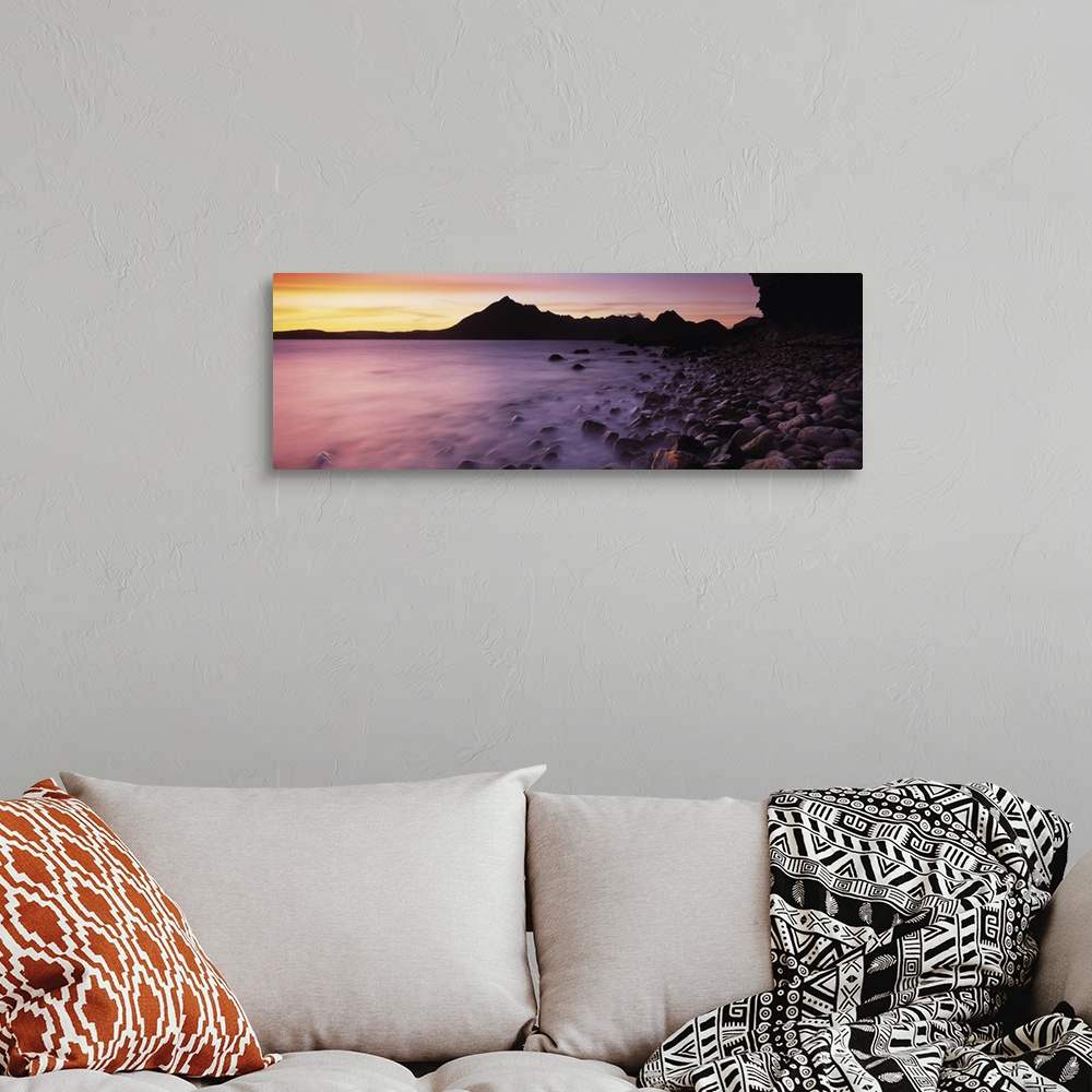 A bohemian room featuring Panoramic photograph of pebble covered shoreline rising from mist with mountain silhouette in the...