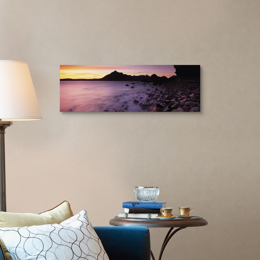 A traditional room featuring Panoramic photograph of pebble covered shoreline rising from mist with mountain silhouette in the...