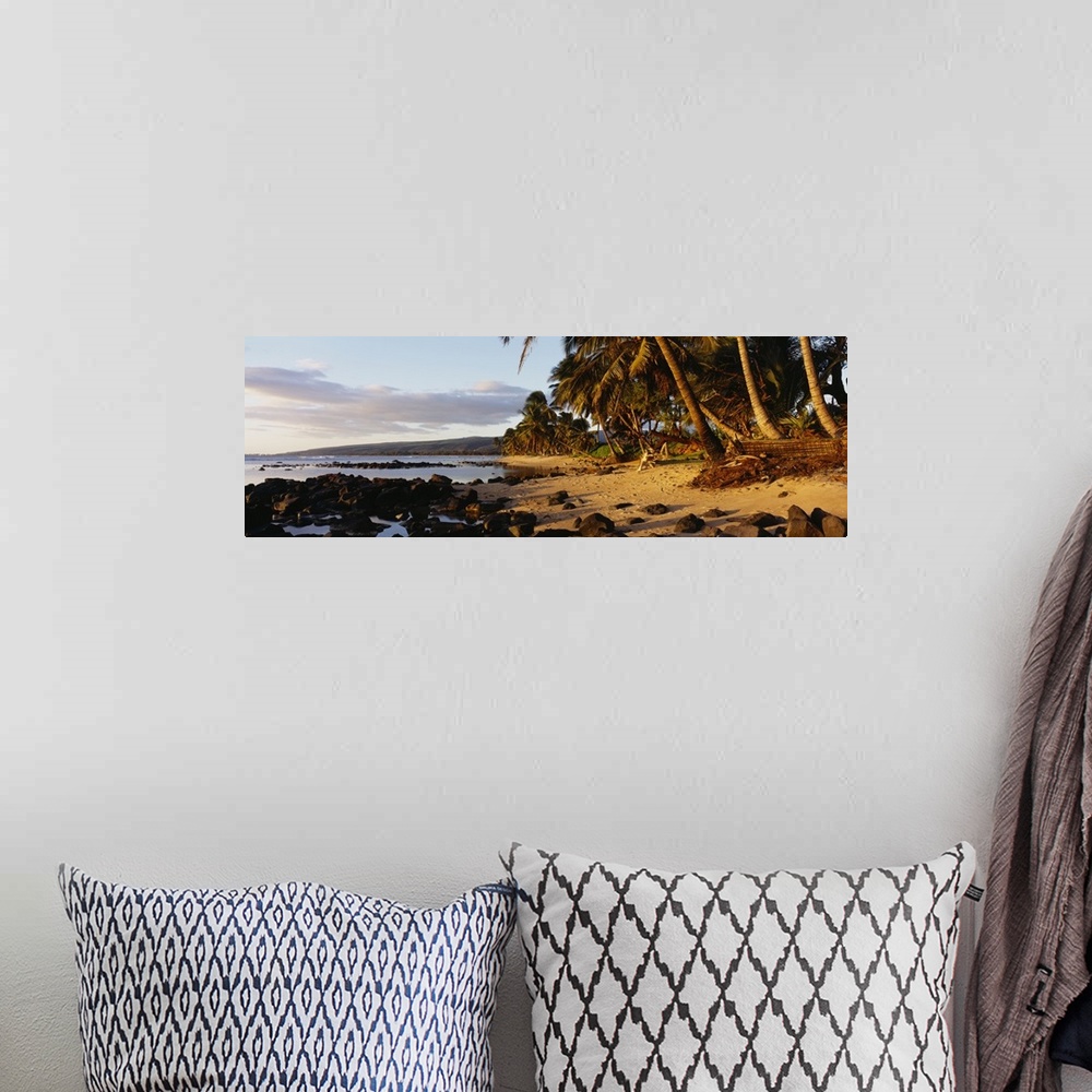 A bohemian room featuring This decorative wall art is a panoramic photograph of sunset on a tropical beach covered with vol...