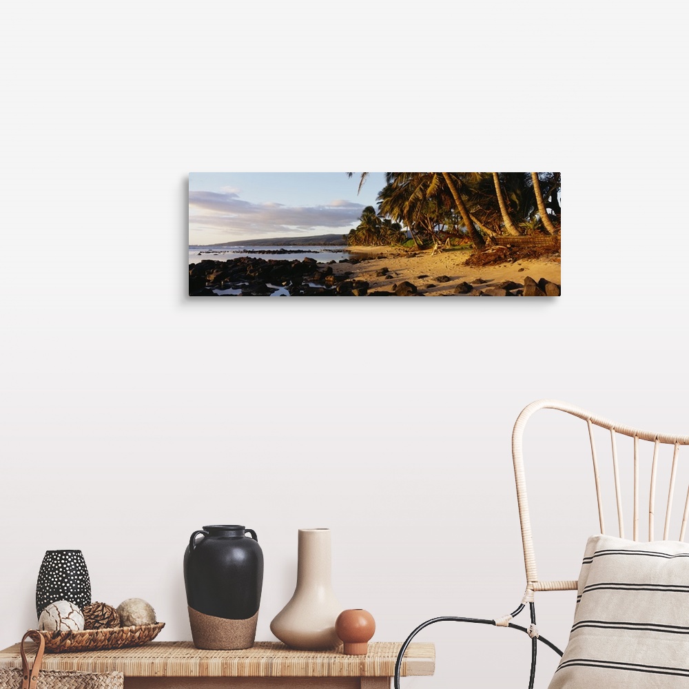 A farmhouse room featuring This decorative wall art is a panoramic photograph of sunset on a tropical beach covered with vol...