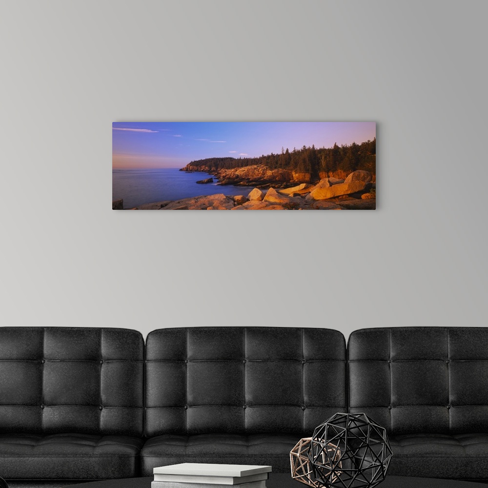 A modern room featuring Wide angle photograph of the rocky shoreline, surrounded by trees at sunset, in Acadia National P...