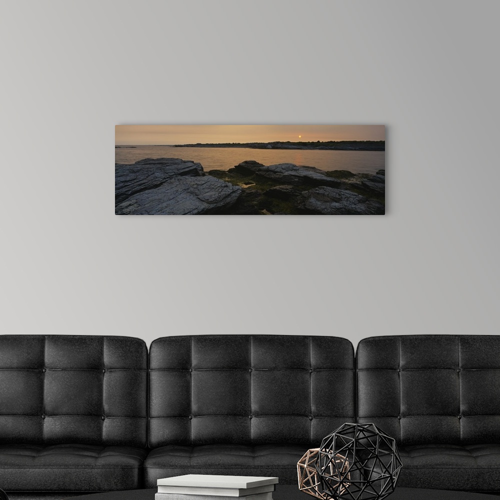 A modern room featuring Wide angle photograph taken atop a rocky coast and looking out over a large body of water during ...