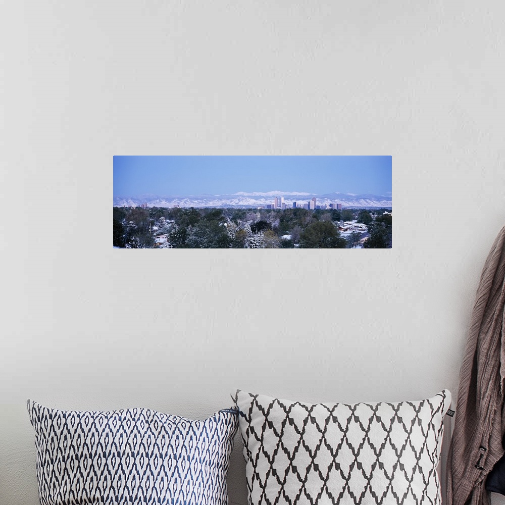 A bohemian room featuring Panoramic photograph on a large wall hanging of a snow covered landscape surrounding houses in fr...