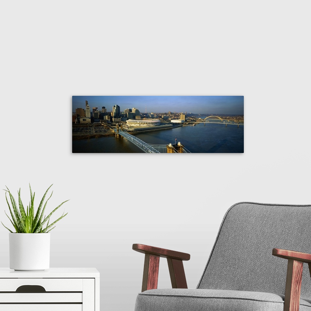A modern room featuring A panoramic view of downtown Cincinnati, the Ohio River and the Roebling Suspension Bridge.