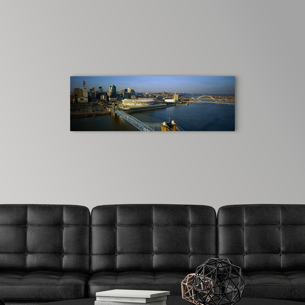 A modern room featuring A panoramic view of downtown Cincinnati, the Ohio River and the Roebling Suspension Bridge.