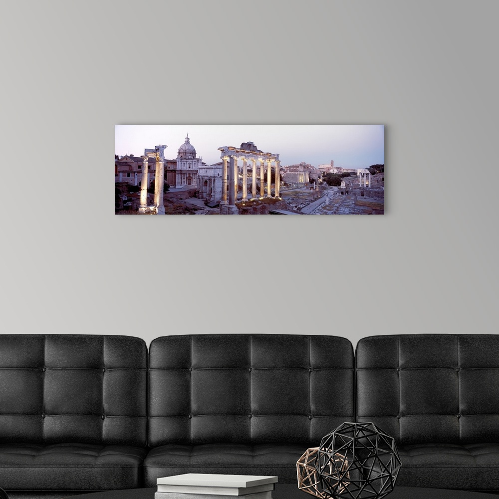 A modern room featuring Panoramic photograph of historic ruins with crumbling and eroded stone pillars and buildings.