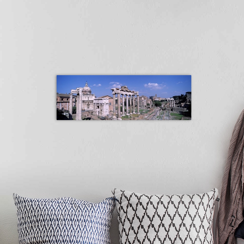 A bohemian room featuring Panoramic photograph taken of structures and buildings in Rome.