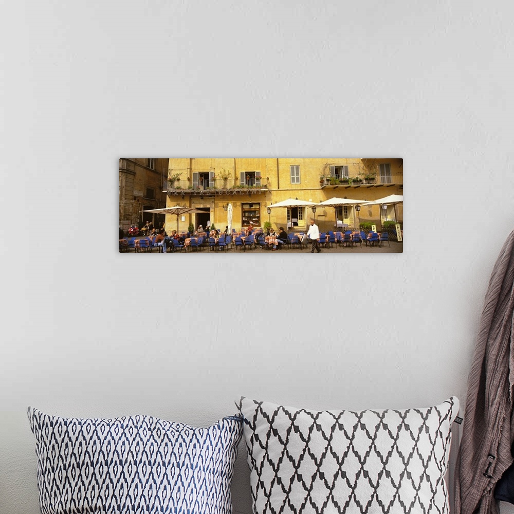 A bohemian room featuring Panoramic photo on canvas of people dining in an outside cafo area in Italy with old buildings in...