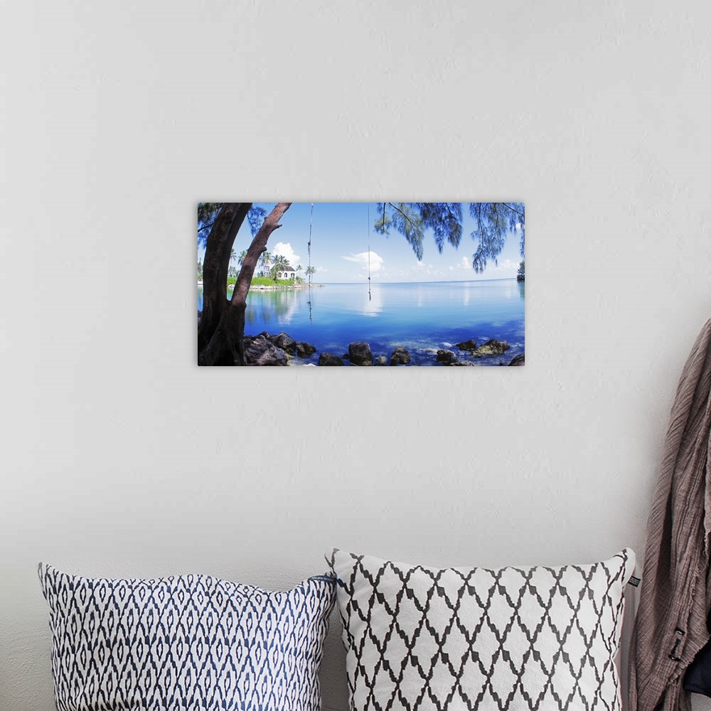 A bohemian room featuring Photograph of calm Key West waters with two rope swings tied to the branch of a drooping pine tre...