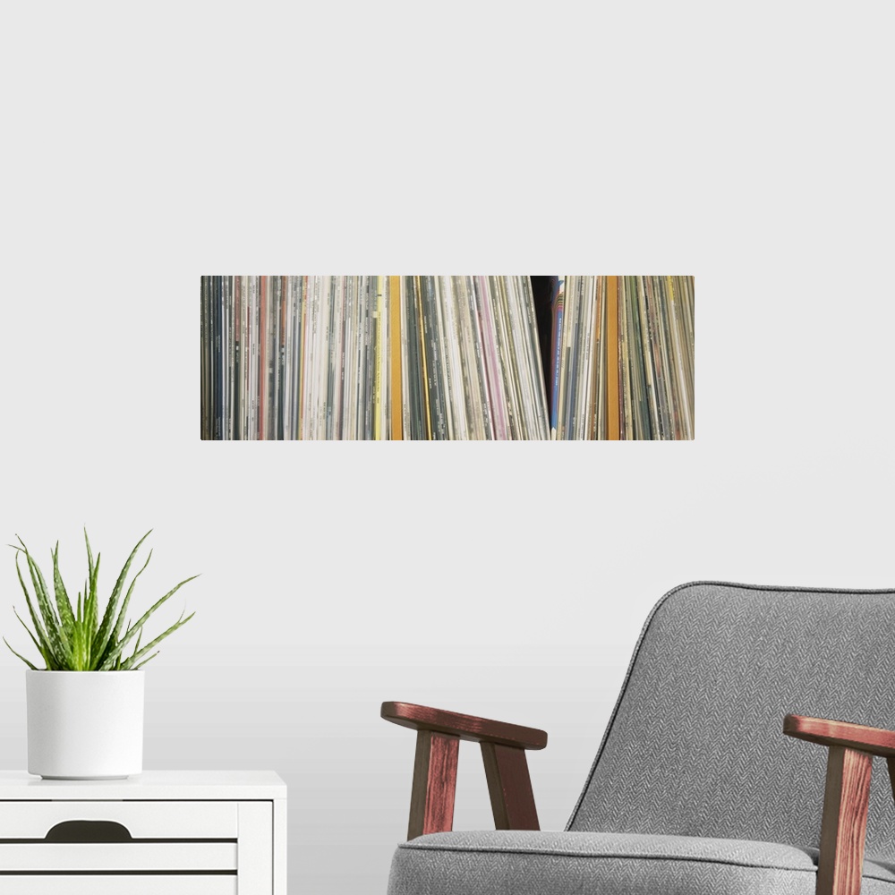 A modern room featuring Panoramic photograph shows an abundance of vinyl albums sitting on a shelf.  Notable artists incl...
