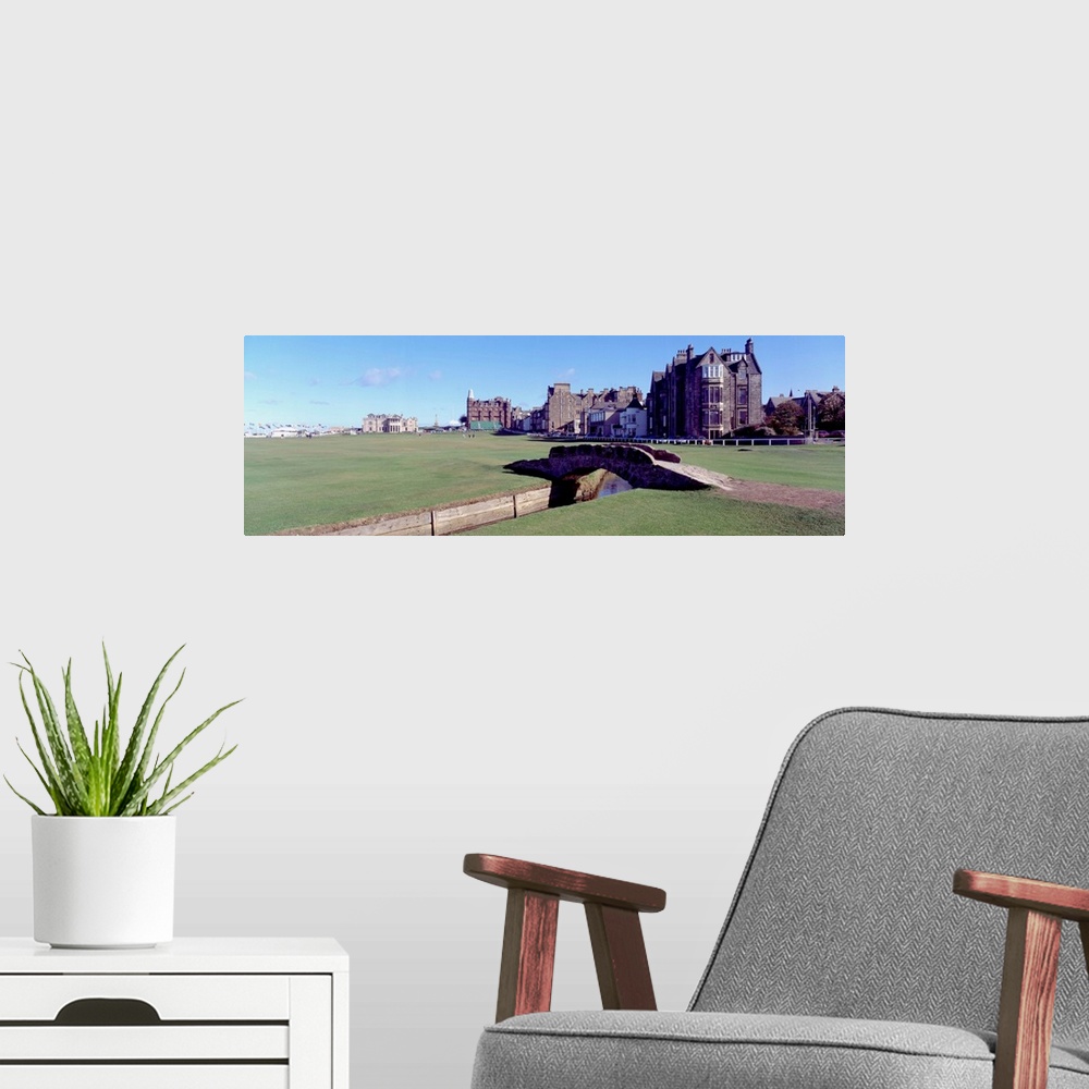 A modern room featuring Panoramic photograph shows Swilcan Bridge connecting two fairways in The Royal and Ancient Golf C...