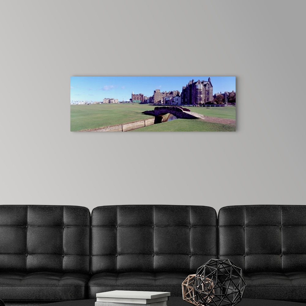 A modern room featuring Panoramic photograph shows Swilcan Bridge connecting two fairways in The Royal and Ancient Golf C...