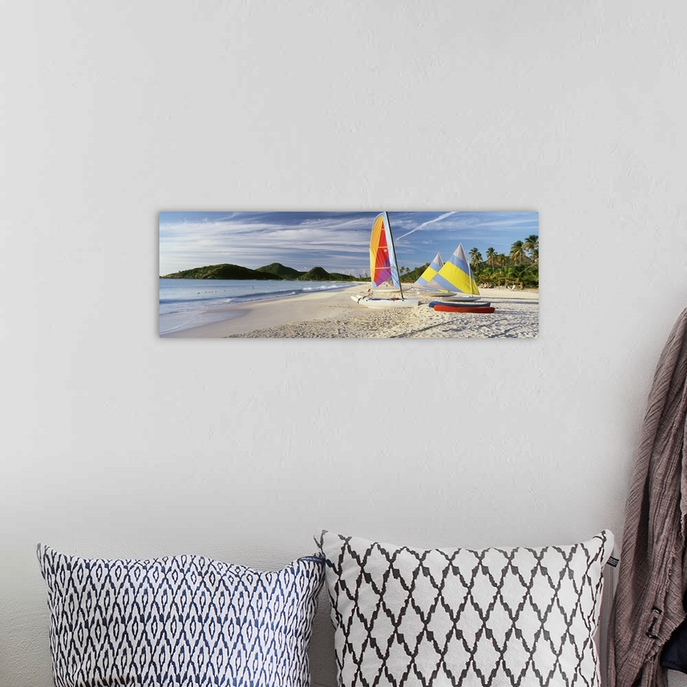 A bohemian room featuring Panoramic photograph of colorful boats on beach with ocean and mountains in the distance.