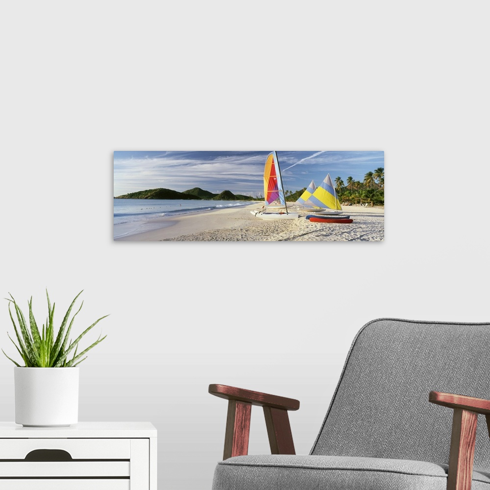 A modern room featuring Panoramic photograph of colorful boats on beach with ocean and mountains in the distance.