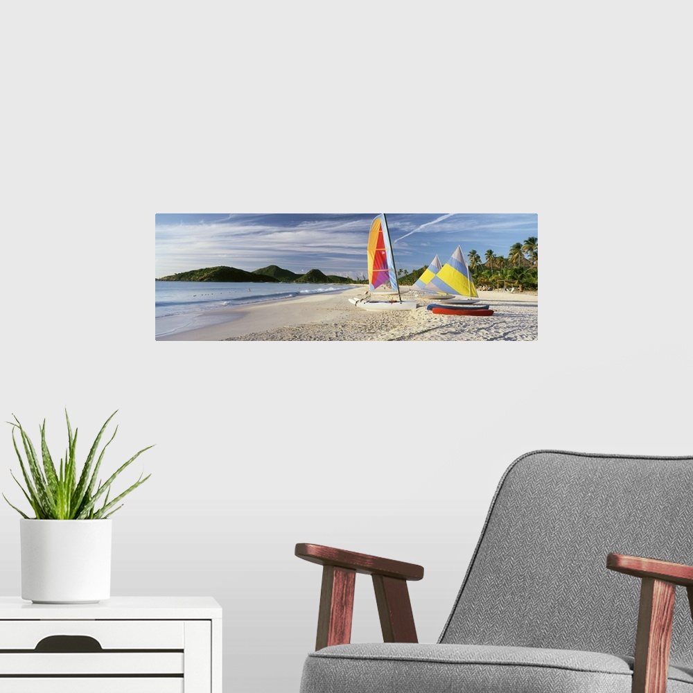 A modern room featuring Panoramic photograph of colorful boats on beach with ocean and mountains in the distance.