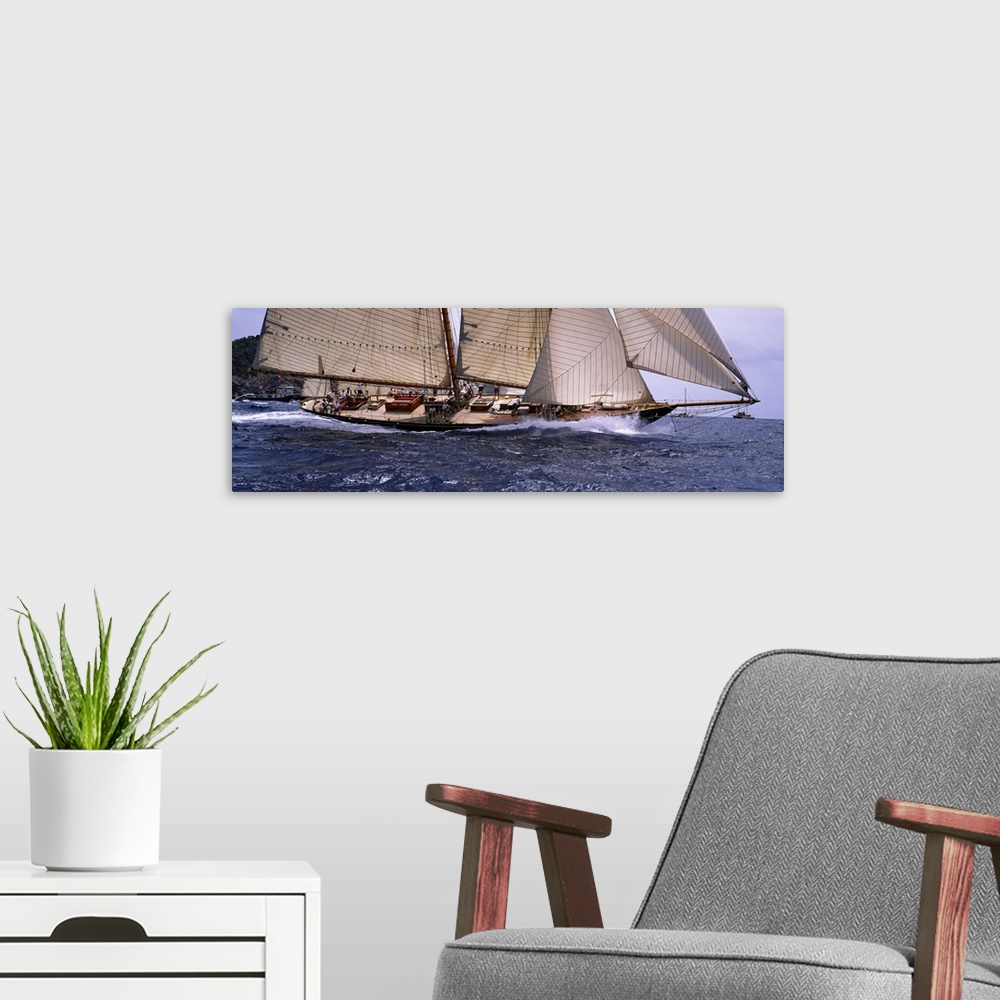 A modern room featuring The body of a large sail boat is photographed in wide angle view as one side leans down into the ...