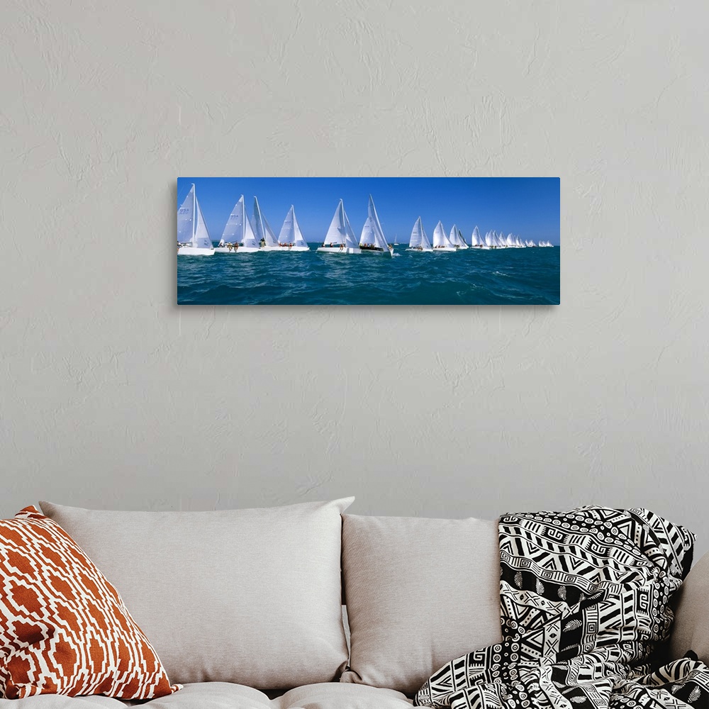 A bohemian room featuring Long and narrow photo print of sailboats lined up in the ocean for a race.