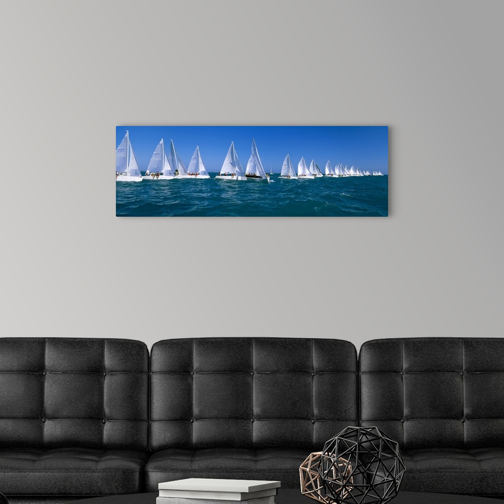 A modern room featuring Long and narrow photo print of sailboats lined up in the ocean for a race.