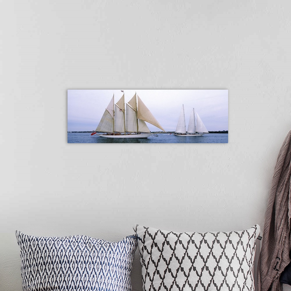 A bohemian room featuring Panoramic canvas photo of two big sailboats in a bay.