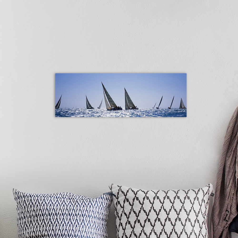 A bohemian room featuring This is a panoramic photograph taken at eye level of multiple boats on the water on a clear day.