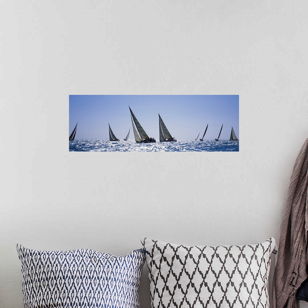 A bohemian room featuring This is a panoramic photograph taken at eye level of multiple boats on the water on a clear day.