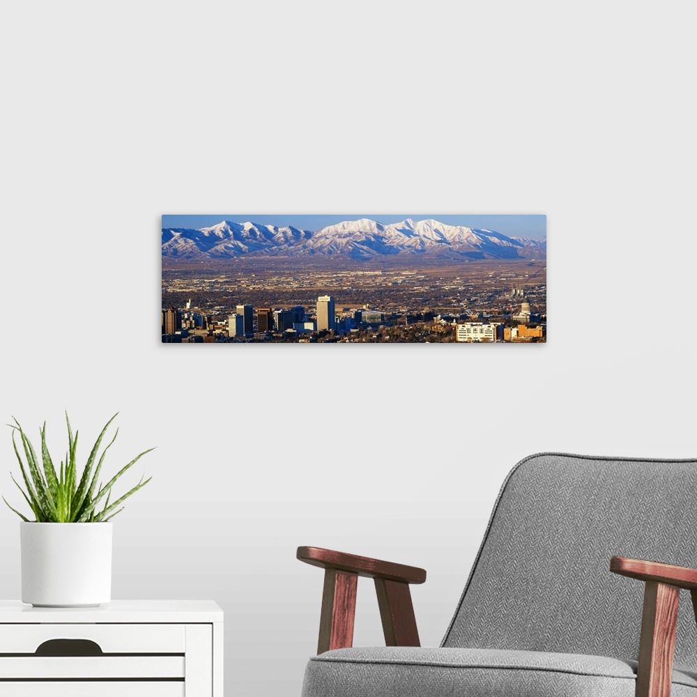 A modern room featuring This panorama features the contrasting terrain of Salt Lake City, Utah and mountain peaks.