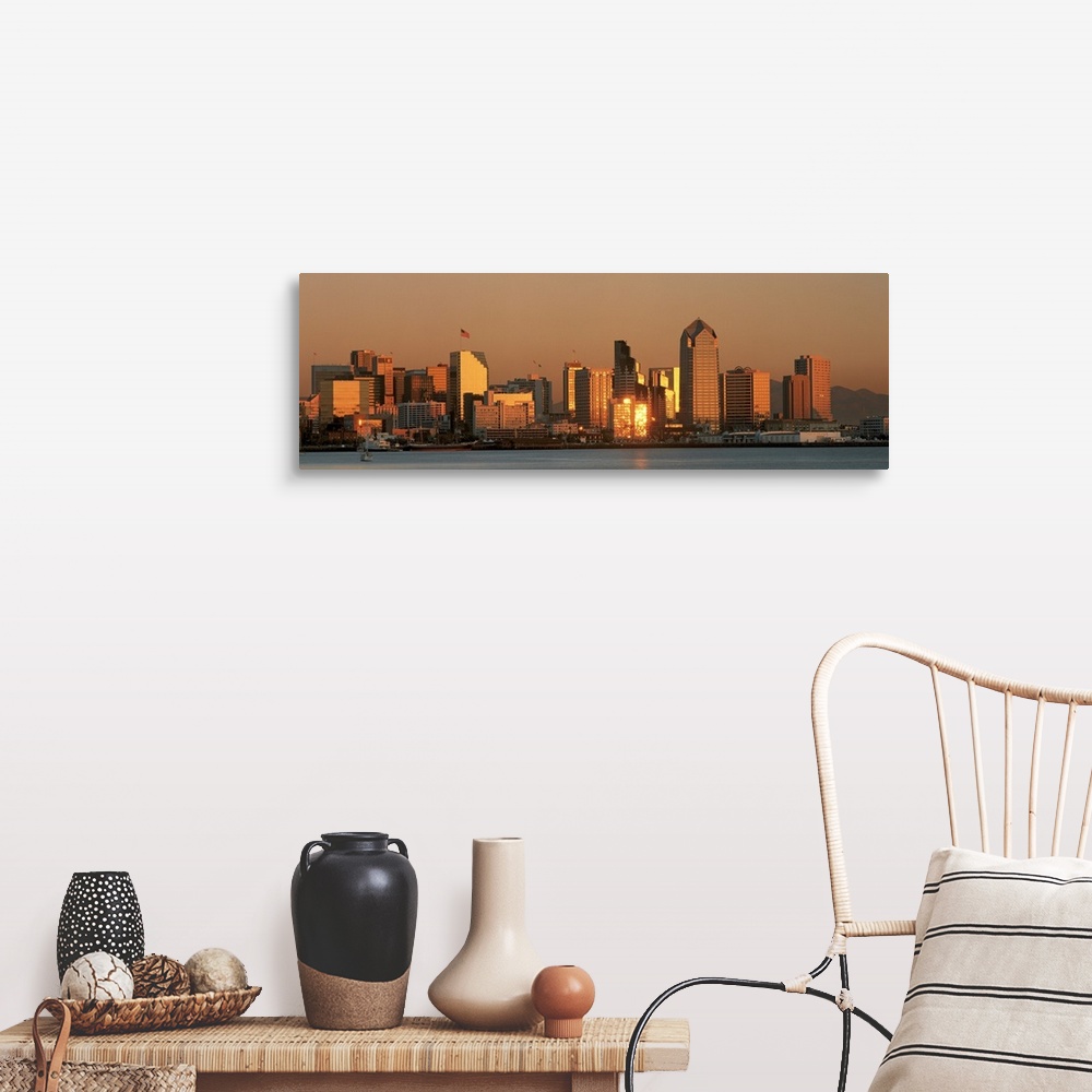 A farmhouse room featuring This wall art is a panoramic photograph of the city skyline reflecting the fading sunlight.