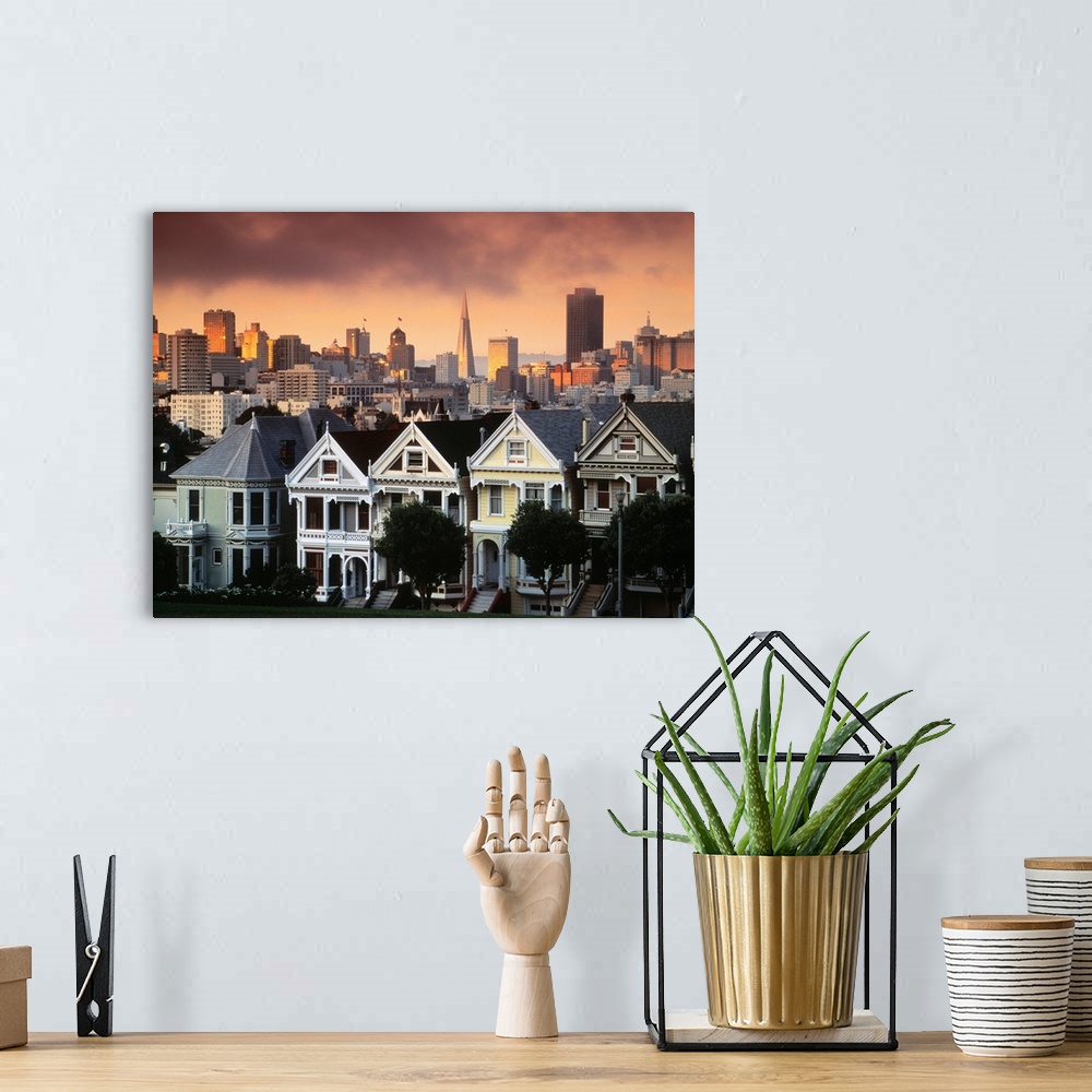 A bohemian room featuring Photograph of pastel colored row houses with city skyline in the background at dusk.