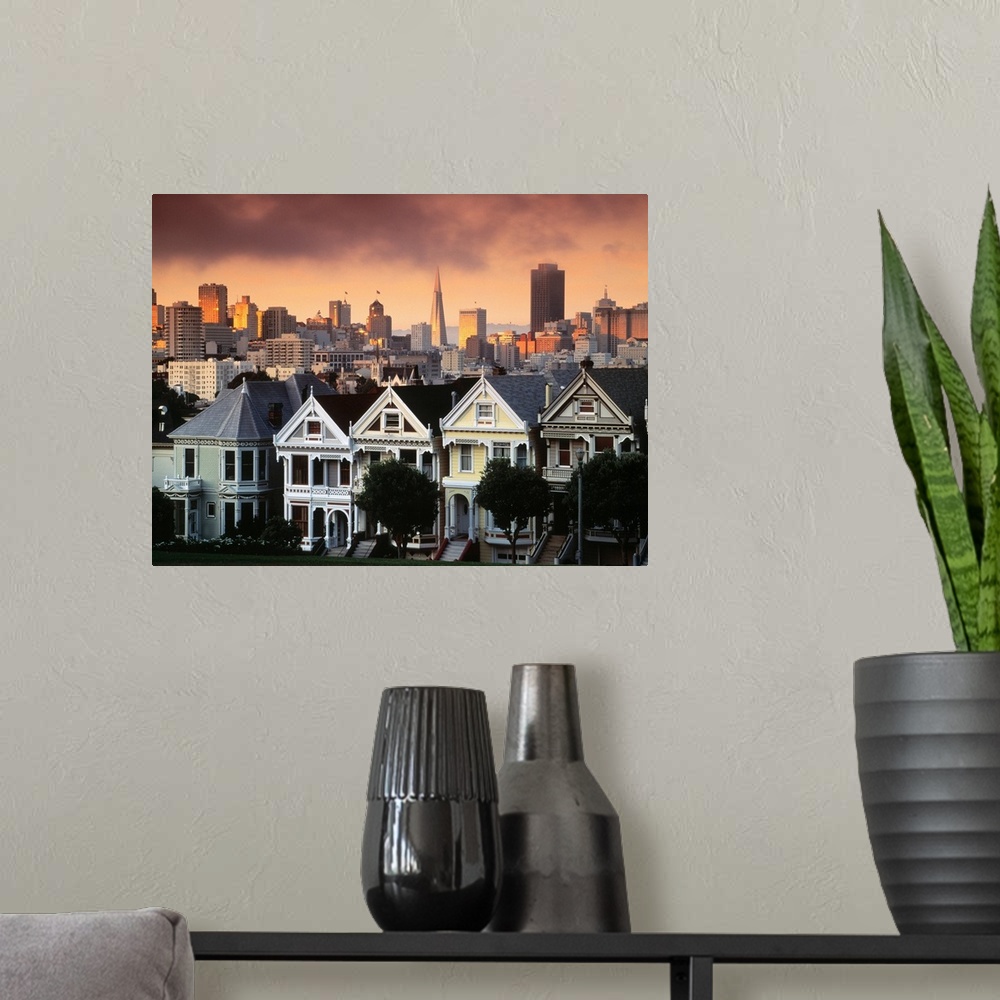 A modern room featuring Photograph of pastel colored row houses with city skyline in the background at dusk.